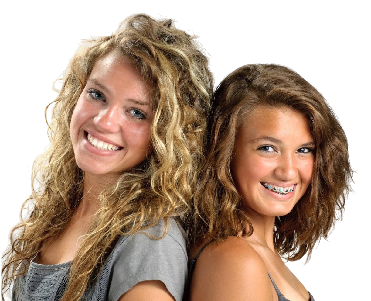 Two smiling teenage patients standing back to back, one wearing braces with blue elastics